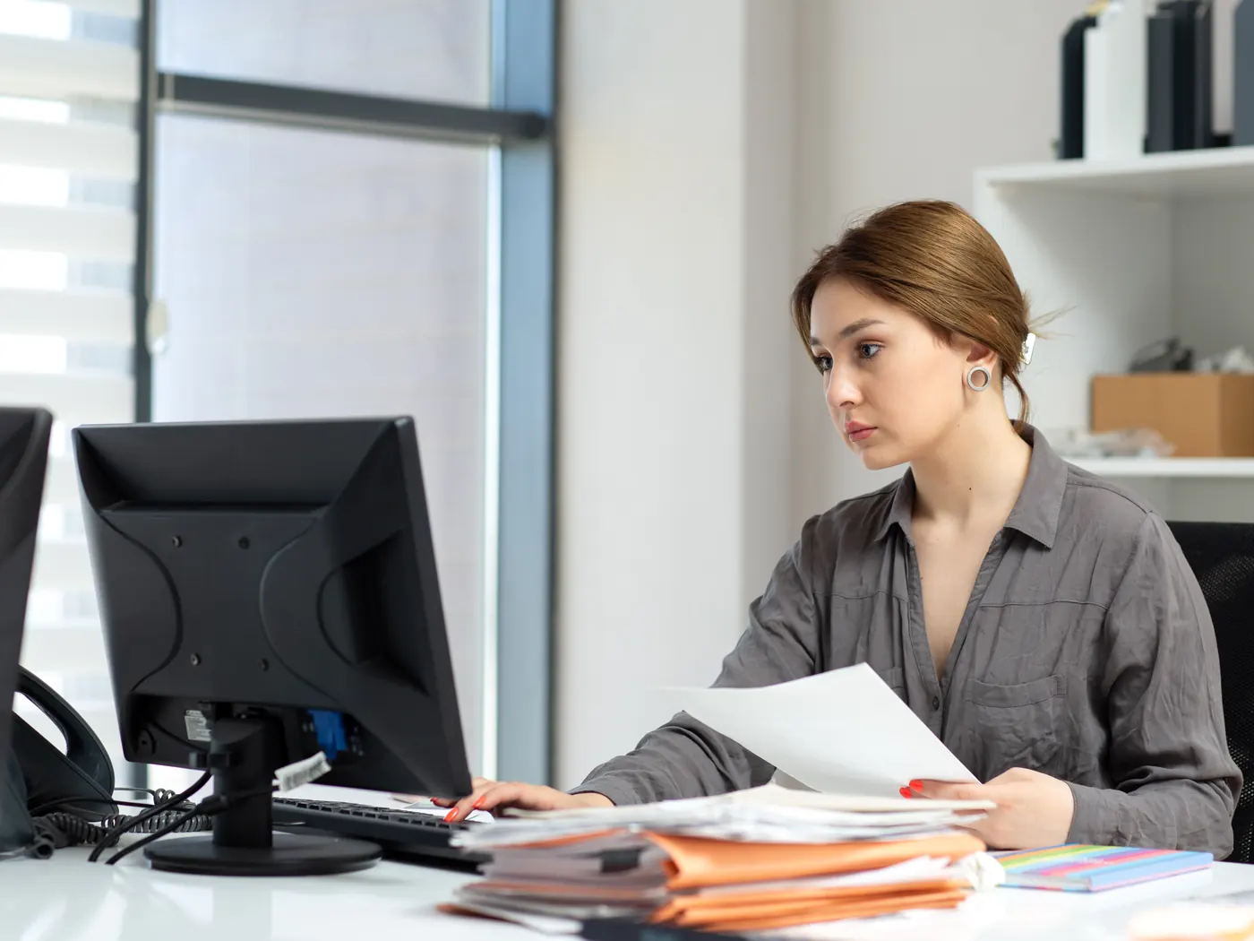 Accountant working with documents and a laptop