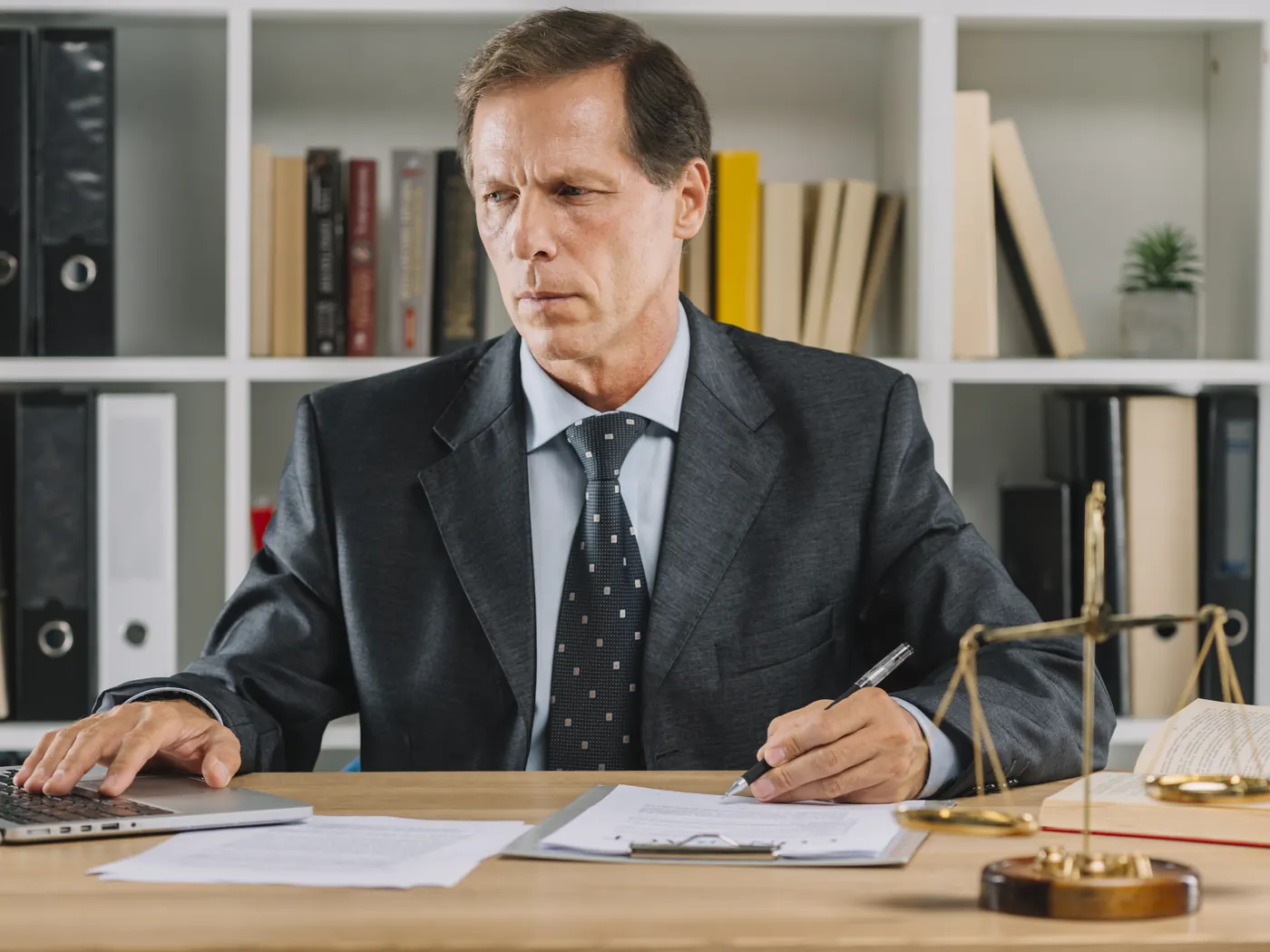 Attorney using a laptop in a courtroom