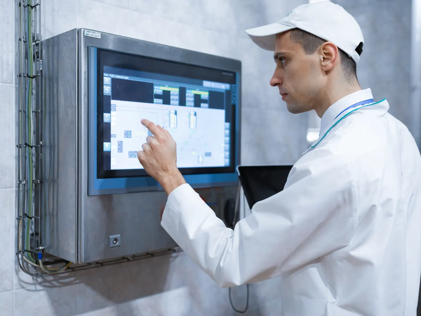 Technician with a laptop on a production floor