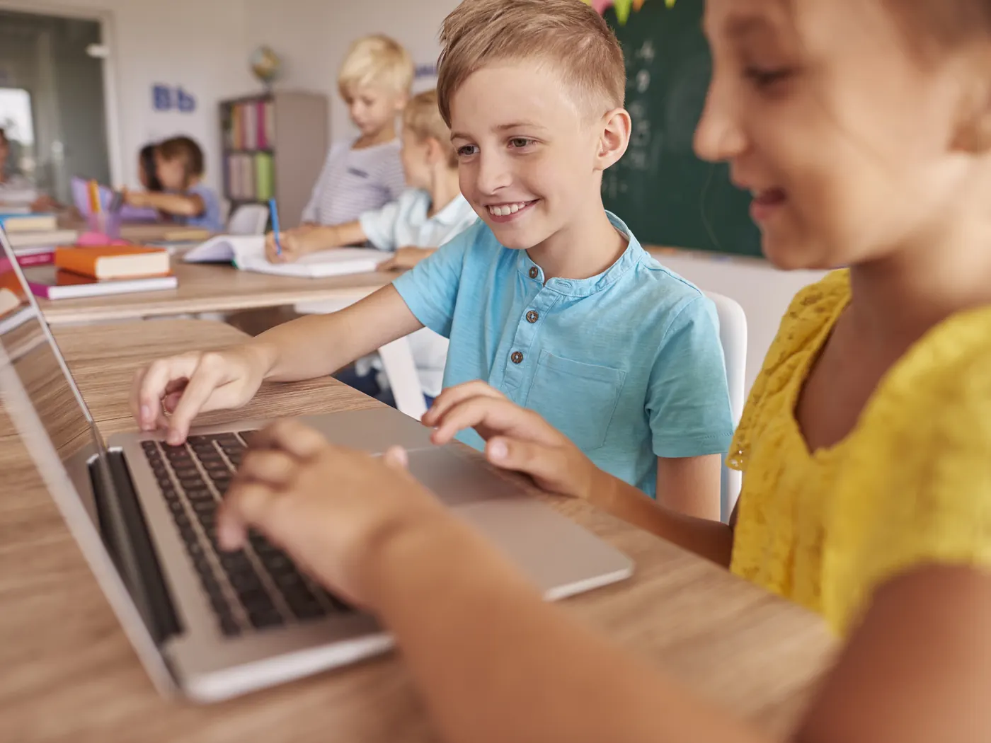 Students using a laptop in class